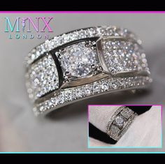 an image of a wedding ring with diamonds on it's sides and the words mmmx london above it