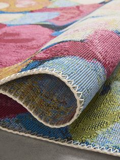 a multicolored area rug with flowers on it