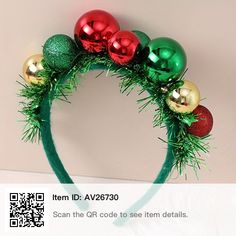 a green headband with red and gold ornaments on it, along with other christmas decorations