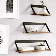 three wooden shelves with books and vases on them