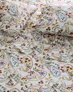 an image of a white fabric with colorful flowers on it