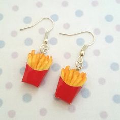 the earrings are made out of plastic and have french fries in them on top of them