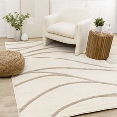 a living room with a white chair and rug