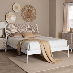 a white bed sitting on top of a wooden floor