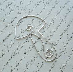 a close up of a metal object on a sheet of paper with writing in the background