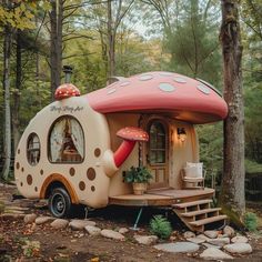 a tiny house with a mushroom like roof in the woods