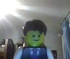 the lego man is wearing a vest and tie