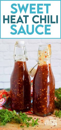 homemade sweet heat chili sauce in two glass bottles on a cutting board with parsley