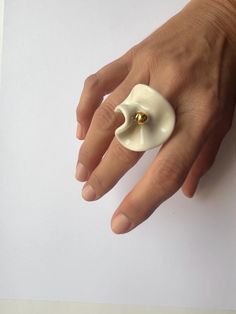 This porcelain ring with 24k gold is made out of porcelain and fired in special ceramic kiln three times on high temperature of 1220oC (2228oF). That high temperature made this ring very strong, but the ring is still fragile.  It's recommended to wear this ring just in special moments in your life, gold can fade by frequent friction and wetting. If you handle with care, the ring will last forever. If you are not sure about your ring size, please compare your ring with a picture of the porcelain Elegant Handmade White Flower Ring, Handmade White Flower Ring, Unique Handmade White Flower Ring, Elegant Handmade Brass Flower Ring, Porcelain Rings Ceramic Jewelry, Clay Embellishments, Porcelain Ring, Ceramic Kiln, Ceramic Rings