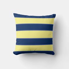 a blue and yellow striped pillow on a white wall