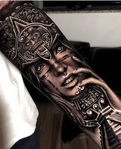 a man's arm with tattoos on it and an image of a woman holding a cross