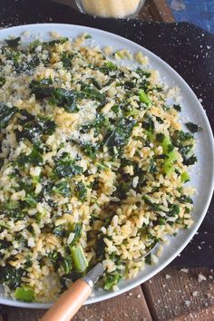 a white plate topped with rice and broccoli