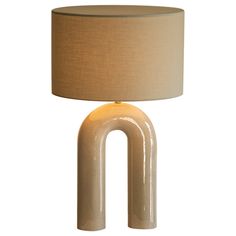 a lamp that is shaped like an o - ring and has a beige shade on it