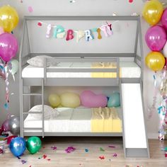 a bunk bed with balloons and streamers on the wall next to it is decorated in pastel colors