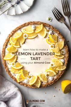 a pie with lemons on it sitting next to a knife and fork, surrounded by other food items