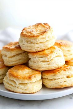 a stack of biscuits sitting on top of a white plate