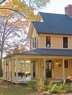 a large yellow house sitting in the middle of a forest