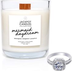 a diamond ring sits next to a jar of cinnamon buns and a white candle