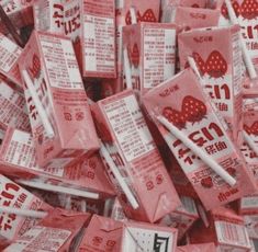 a pile of red packets with white writing on them and some chopsticks in the middle