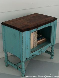 an old blue cabinet with books in it