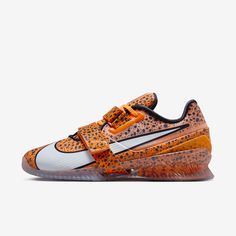 an orange and white nike shoe with leopard print on the upper part of the shoe