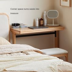 a bed sitting next to a desk with a mirror on top of it and other items