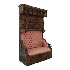 an ornate wooden bench with pink upholstered seat and carved wood trimmings