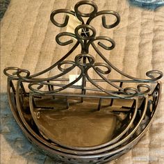 a decorative metal shelf on top of a bed