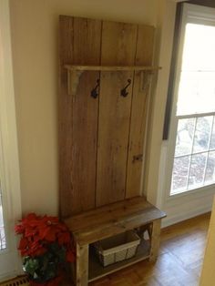 a wooden bench sitting next to a window