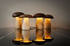 three lamps sitting on top of a table next to each other