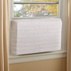 a white mattress sitting on top of a window sill