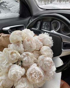 a bunch of white flowers sitting inside of a car