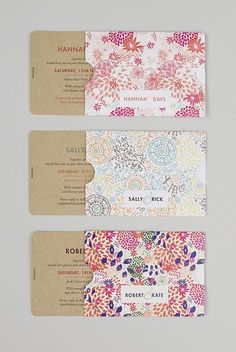 three business cards with floral designs on them