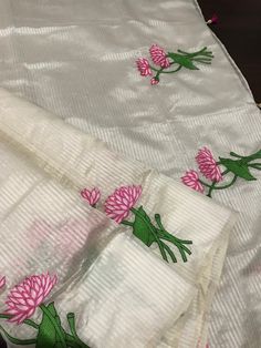 This is a beautiful handloom silk by silk maheswari silk saree in off-white in custom HAND embroidered lotus motif design. Saree is featherlight. It is extremely elegant. Saree pallu is finished with tassels. Falls and pico are done already. Blouse is unstitched and has embroidered lotus motifs. We chose lotus with leaves embroidery to complement the white body of this silk saree. Embroidery was done only in the lower half of the saree,  to maintain the simplicity of the saree, yet adding a pop of colour. Colour may vary slightly depending upon the lighting and individual device settings. Handloom products may have some irregularities unlike power loom products. All sales are final. Dry clean only. White Silk Traditional Wear With Floral Embroidery, Festive Cotton Silk Saree With Floral Embroidery, Off White Chanderi Traditional Wear With Floral Embroidery, White Silk Dupatta With Floral Embroidery, White Silk Fabric With Floral Embroidery, Embroidered Off White Saree, Off White Embroidered Saree Fabric, Festive White Embroidered Cotton Silk Fabric, White Silk Fabric With Resham Embroidery