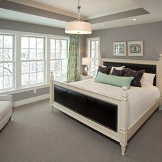 a large bedroom with gray walls and carpeted flooring is pictured in this image