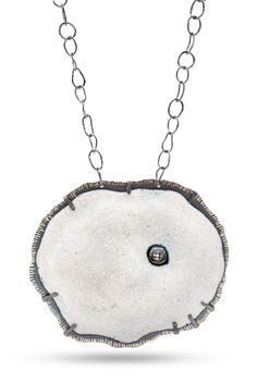 a white necklace with a black diamond in the center and chain around it, on a white background