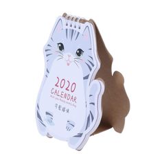 a white and gray cat shaped calendar on a stand