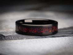 a black ring with red and orange inlays