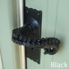 an octopus door handle on a green door