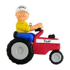 a toy tractor with a man riding on it