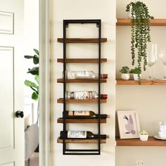 the shelves have wine bottles and glasses on them, along with other items such as plants