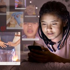 a woman looking at her cell phone while she's surrounded by images of other women