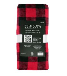 the red and black plaid flannel fabric is folded on top of each other