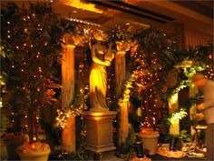 the statue is surrounded by greenery and lite - up lights in this room