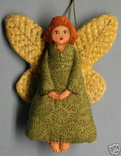 an angel ornament hanging on a wall