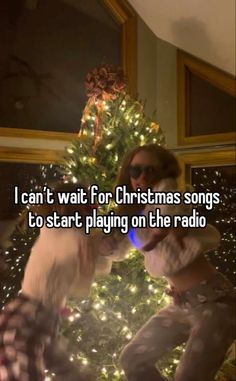 a woman standing in front of a christmas tree with the caption i can't wait for christmas songs to start playing on the radio