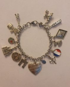 Silver Paris Chain Bracelet is 7.5 inched long, however we can make it any size you need.  If you need a size different from the 7.5 inch please just note the size you need in the message to seller when placing your order and we will follow your directions.  Bracelet is stainless steel and charms are of various different metals.  Bracelet comes with every charm shown in the photos. If you look at picture number 2 in the photo section, all of the charms are noted. Please feel free to message us with any questions you may have.  Thank you so much! Paris Charm Bracelet, Inner Monster, Paris Bracelet, Charmed Show, Diamond Fashion Rings, Bracelet Chain, Bracelet Charm, Number 2, Diamond Fashion