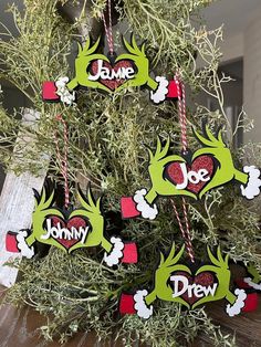 a christmas tree with ornaments hanging from it's branches and name tags on them