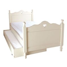 a white bed frame with hearts on the headboard and foot board, against a white background