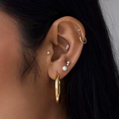 Introducing our stunning collection of 9k Solid Gold ear party pieces Dainty, Sparkly & Stackable styles designed to mix & match, creating a look that’s personal to you! These timeless treasures are made to last a lifetime, making them perfect for everyday wear in specialist ear piercings. Fits: Lobe, Upper Lobe & Conch Wear Pearl when manifesting luck and wealth. Read more in our guide to beautiful gemstones here  Buying a gift for someone special? Why not add the finishing touch with one of our gorgeous gift cards and gift bags? Click here to view Ear Stack With Conch, Pearl Ear Piercings, Ear Party Piercings, Cute Ear Stacks, Stackable Earring Ideas, Classic Teardrop Single Hoop Earring, Elegant Yellow Gold Teardrop Cartilage Earrings, Elegant Tarnish Resistant Piercings, Fine Jewelry Teardrop Earrings For Everyday